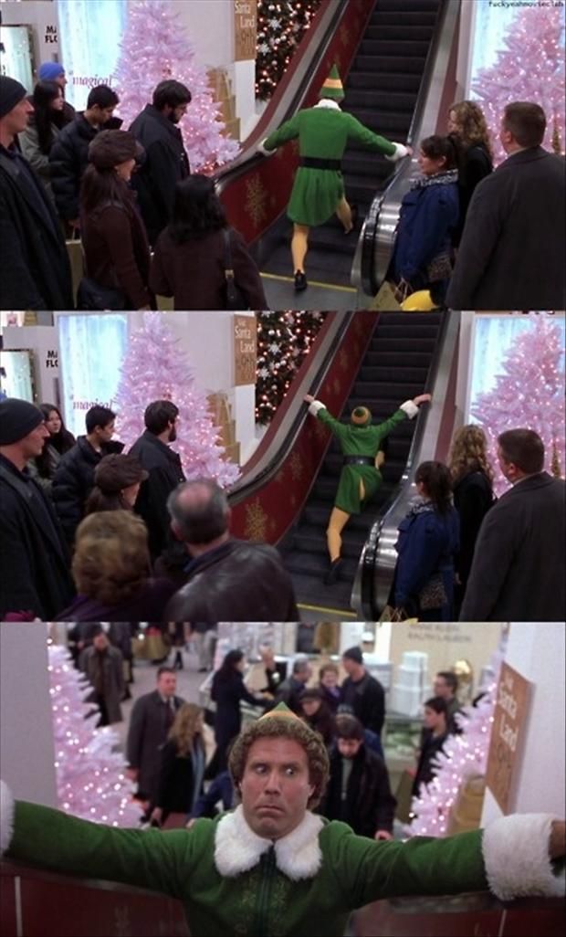 the elf is coming down the escalator in front of many people at christmas time