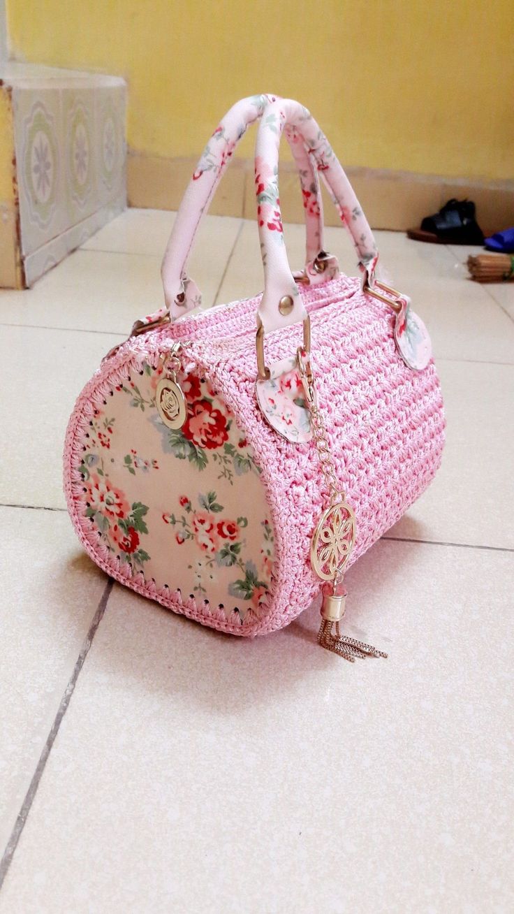 a pink purse sitting on top of a tiled floor