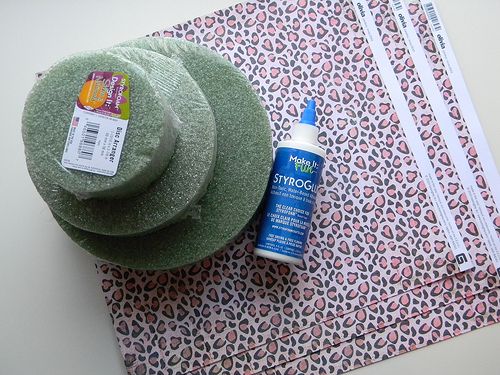 a green hat sitting on top of a piece of paper next to a bottle of deodorant