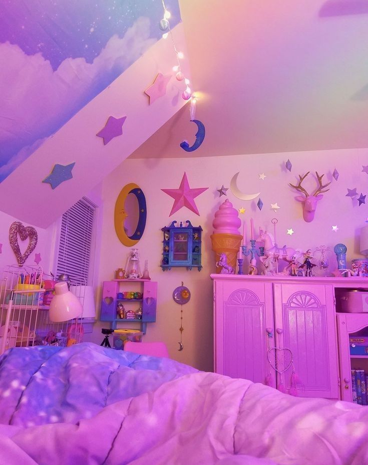 a child's bedroom decorated in pastel colors with stars and moon decorations on the ceiling