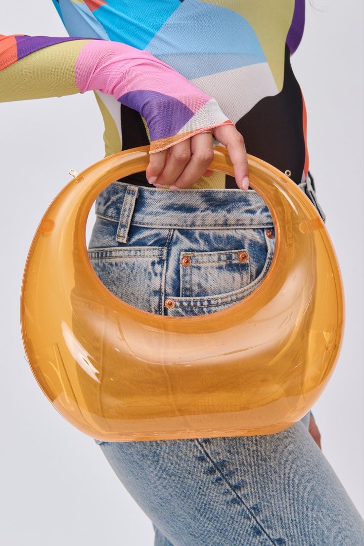 A stylish and modern Acrylic Evening Bag, perfect for the fashion-forward individual. The transparent design, structured shape, and top handle provide an elegant touch, while the secure snap frame closure ensures the safety of your belongings. The unlined interior allows for personal style expression, and the included extra chain strap adds versatility. The bag measures 10.375 inches in length, 4 inches in width, and 3.75 inches in height, making it a must-have accessory. Modern Evening Bag With Handle Drop For Parties, Modern Summer Formal Shoulder Bag, Modern Formal Summer Shoulder Bag, Trendy Plastic Shoulder Bag For Party, Modern Evening Bag For Party With Top Carry Handle, Modern Evening Bag With Top Carry Handle For Parties, Modern Summer Party Shoulder Bag, Trendy Party Shoulder Bag With Round Handle, Modern Clear Evening Bag