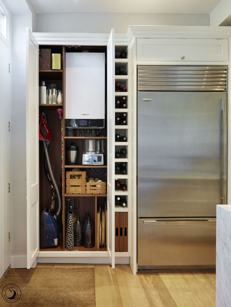 an organized pantry in the corner of a kitchen