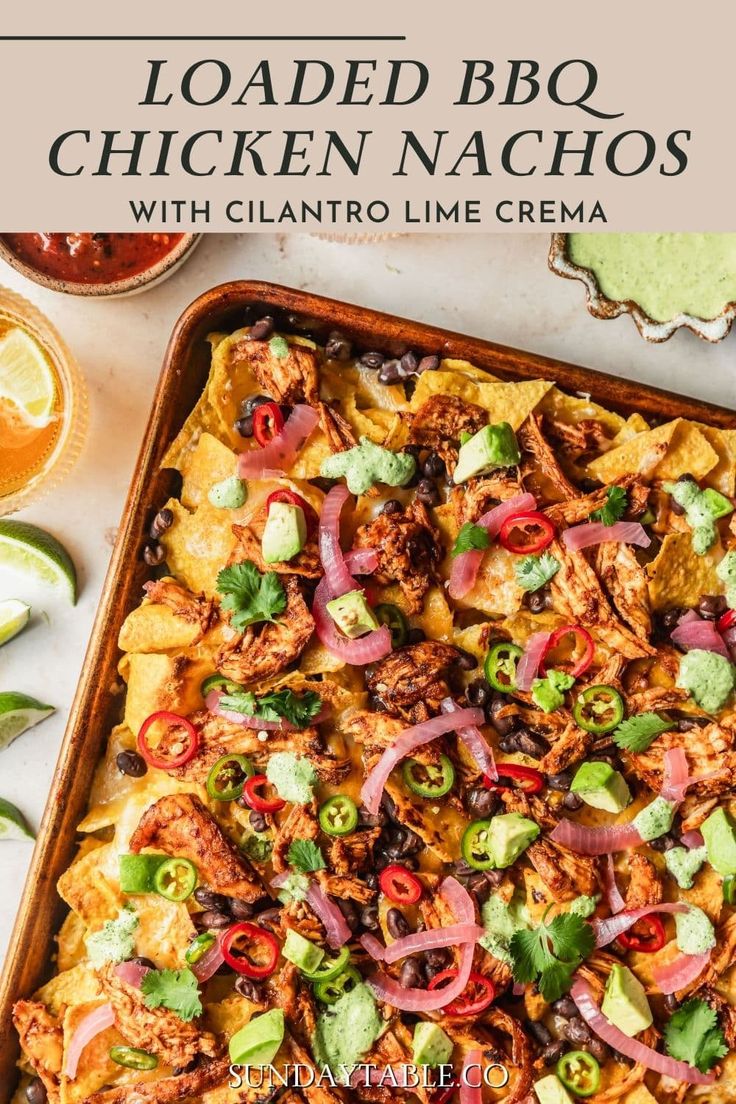 loaded bbq chicken nachos with cilantro lime crema on top