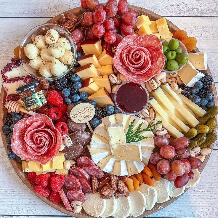 a platter filled with different types of cheese and meats