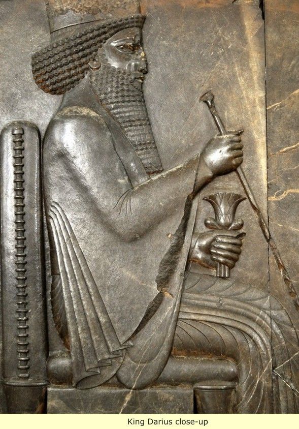 an ancient egyptian statue with a man holding a staff