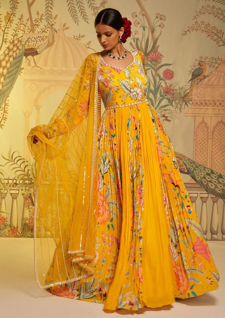 Editor's Note The yellow amber floral anarkali and dupatta is a stunning ensemble that exudes timeless charm and elegance. The vibrant yellow color and intricate floral motifs create a captivating look, while the flowing silhouette adds grace and movement. Paired with a matching dupatta, this outfit is perfect for special occasions and celebrations. Color: Yellow Fabric: Anarkali: crepe silk & georgette crepe, dupatta: swiss net Components: Anarkali and dupatta Occasion: Festive Fit: Fitted at w Floral Anarkali, Yellow Anarkali, Floral Frocks, Cozy Sweater Dress, Beautiful Maxi Dresses, Floral Embroidered Top, Trendy Blouse Designs, Anarkali Dress, Fabulous Dresses