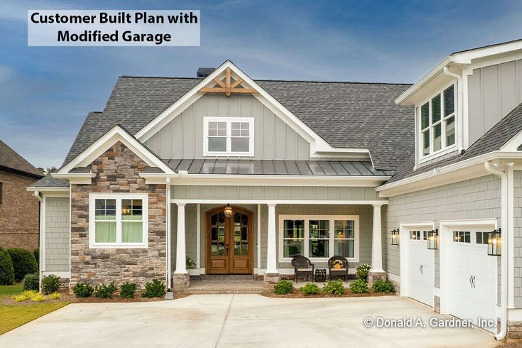 a gray and white house with the words customer built plan with modified garage