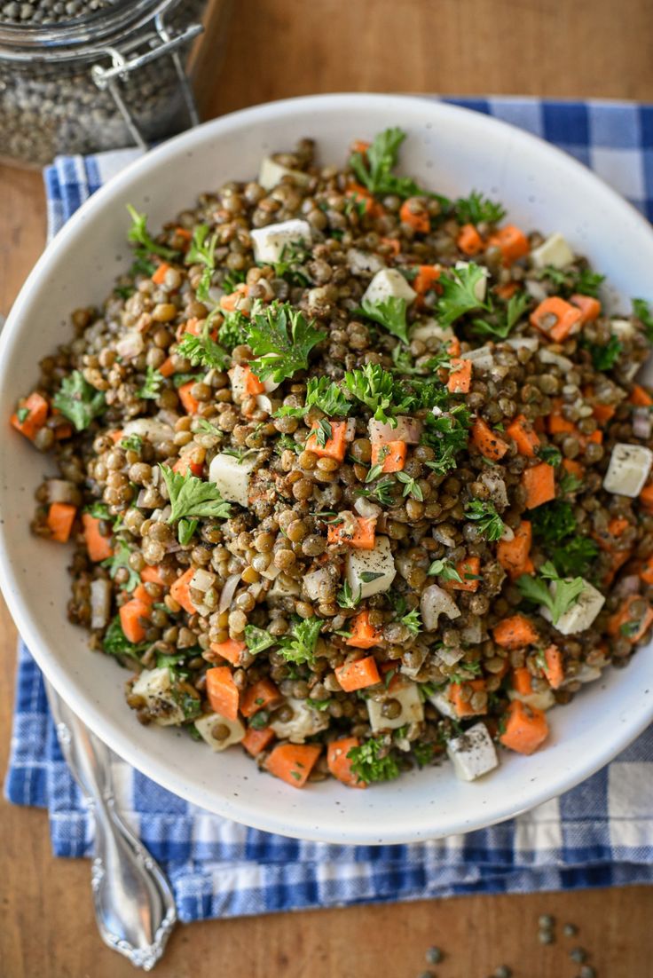 a white bowl filled with lentils and carrots