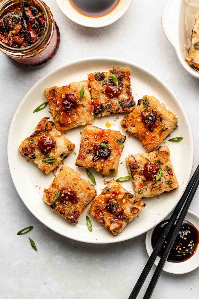 tofu on a plate with chopsticks and sauce