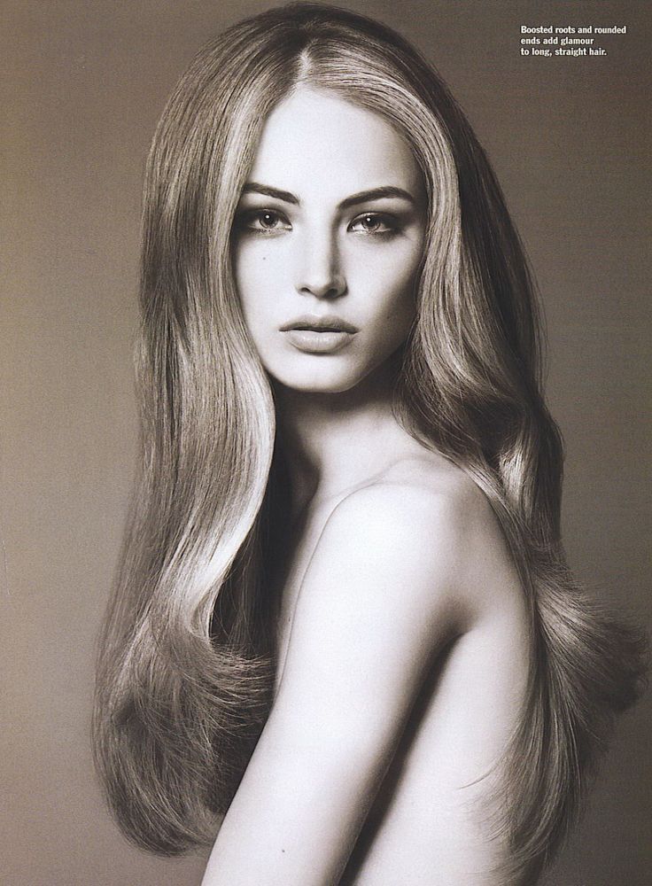 a black and white photo of a woman with long blonde hair posing for the camera