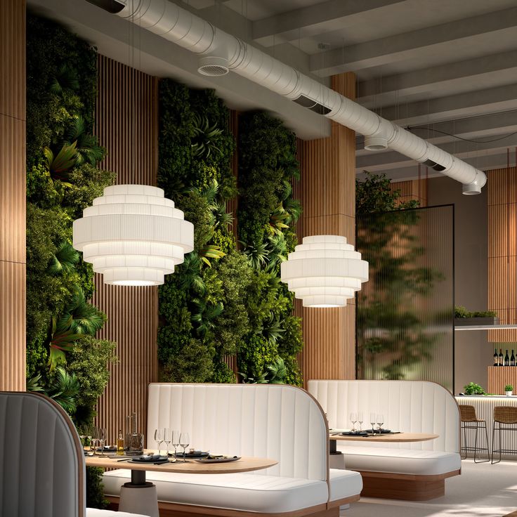 the restaurant is decorated with greenery and white furniture