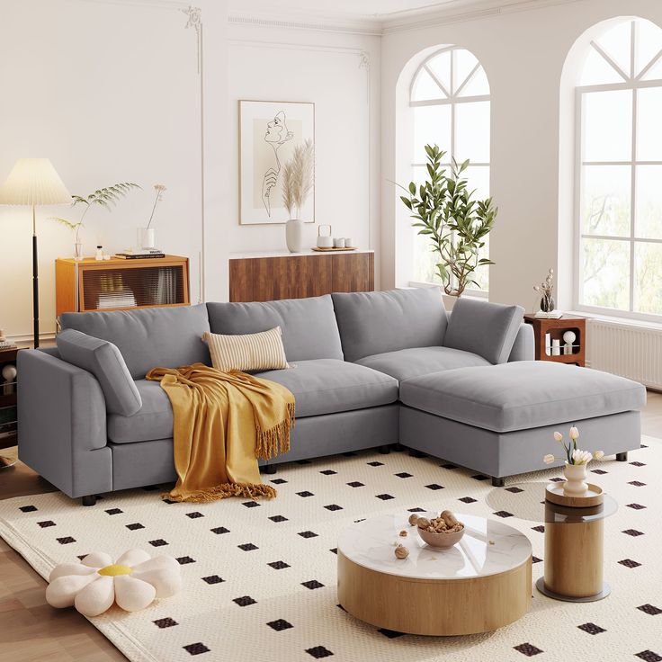 a living room with a sectional couch and coffee table