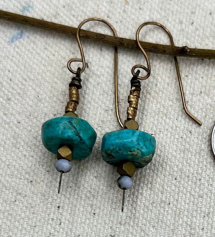 Simple drop and dangle earrings bring a touch of rare turquoise discs paired with brass findings. Can't go wrong with these... Turquoise Metal Dangle Earrings, Turquoise Brass Earrings For Pierced Ears, Turquoise Metal Beaded Dangle Earrings, Earthy Turquoise Dangle Jewelry, Turquoise Dangle Earrings With Patina, Turquoise Patina Drop Earrings, Turquoise Dangle Earrings In Brass, Turquoise Brass Drop Earrings, Turquoise Dangle Brass Earrings