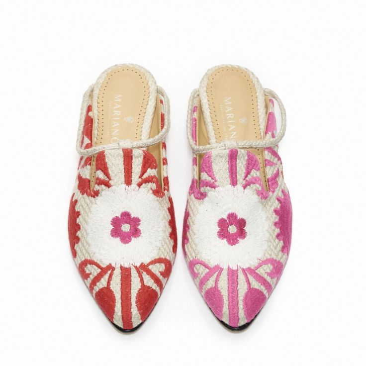 a pair of pink and white shoes with flowers on them