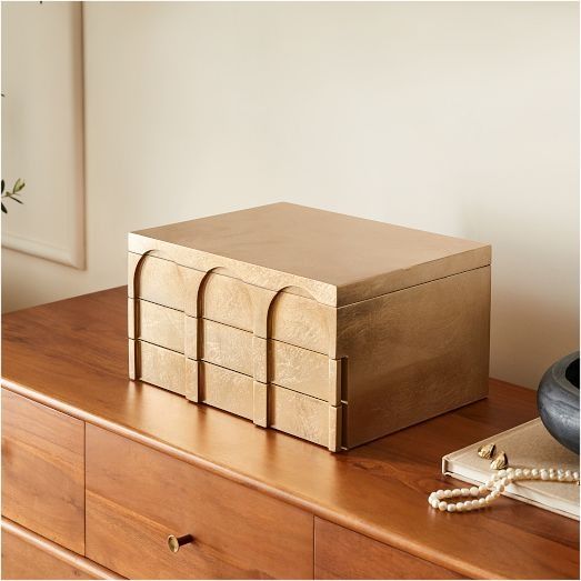 a wooden box sitting on top of a dresser