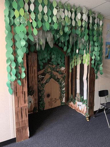 a room decorated with paper trees and other decorations