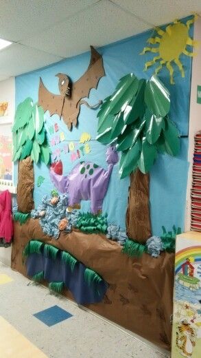 a classroom decorated with paper mache animals, trees and other things on the wall