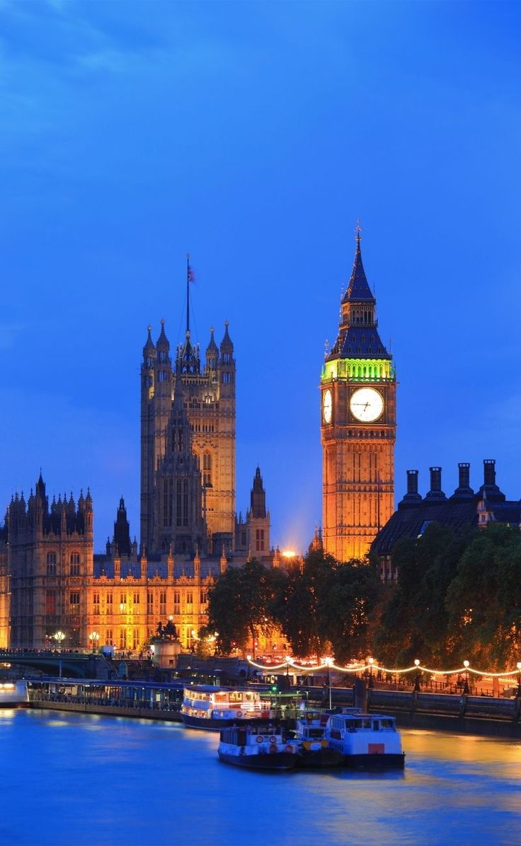 the big ben clock tower towering over the city of london, england at night time