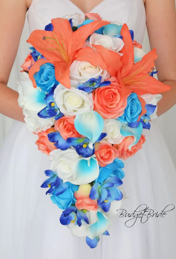 a bridal bouquet with orange, blue and white flowers in the bride's hand