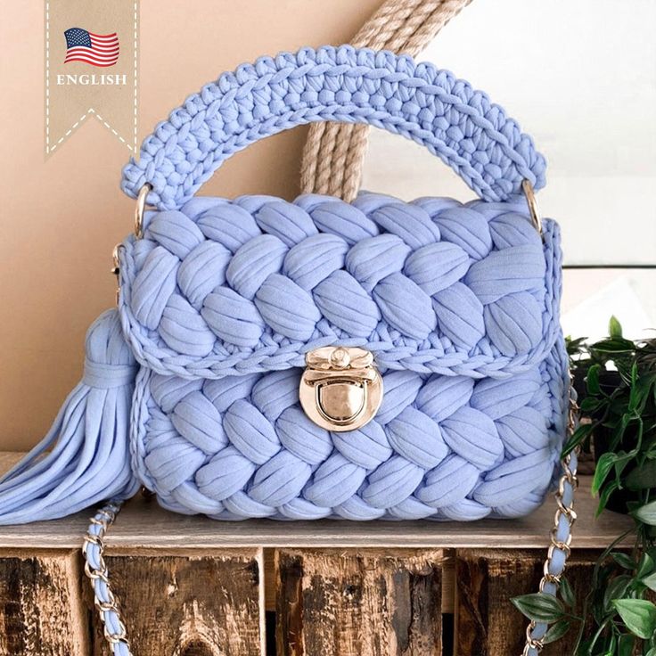 a blue purse sitting on top of a wooden table