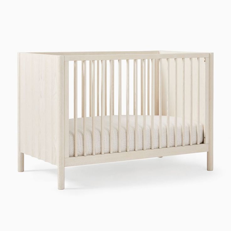 a baby crib with white sheets on the bottom and sides, in front of a white background