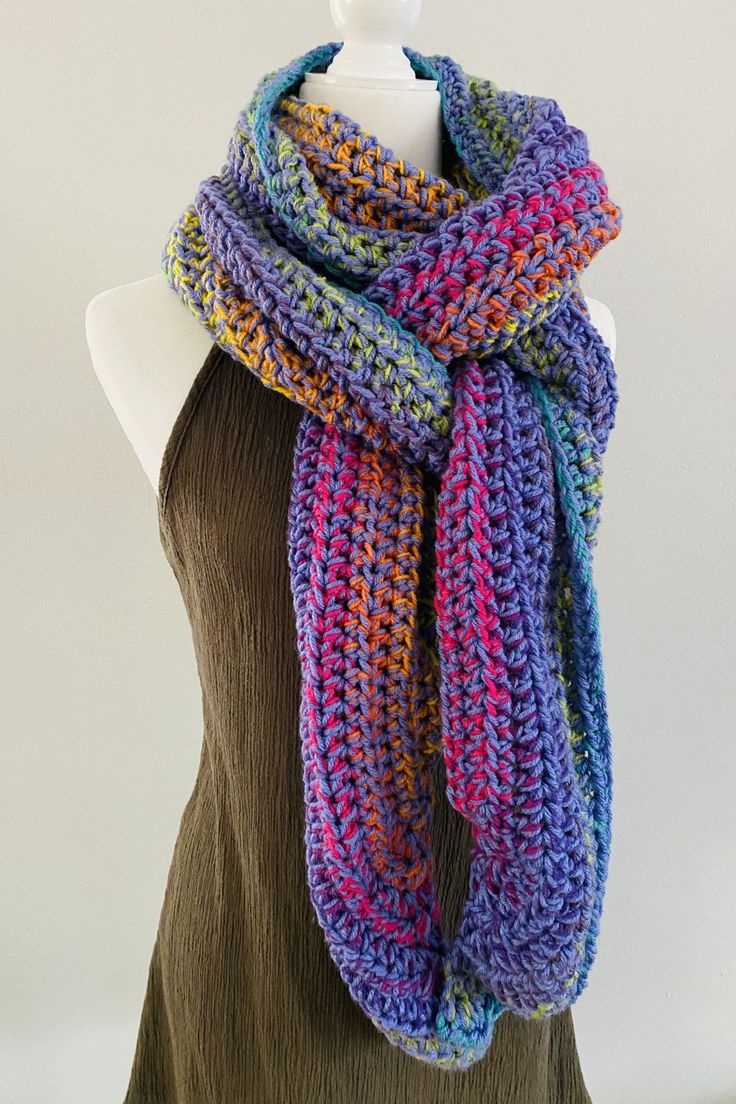 a mannequin wearing a multicolored knitted scarf