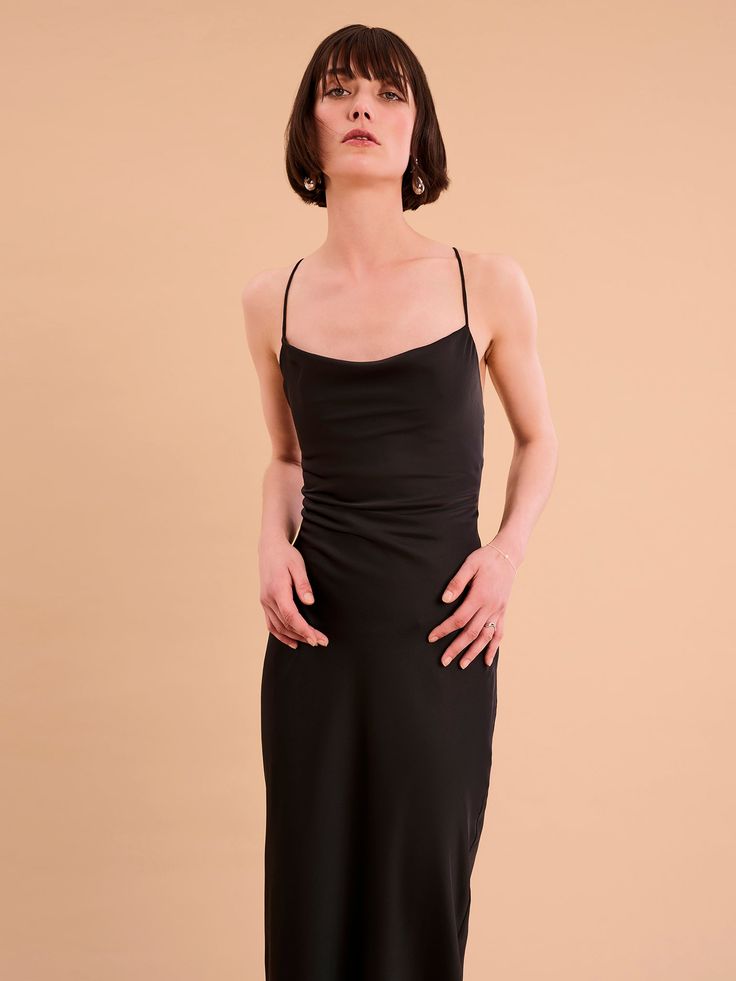 Ginny is an update on our classic Riviera in a gorgeous new maxi-length. She's got the same cowl neck and backless lace-up detail and is crafted from our signature slinky satin made using 100% recycled polyester. In a sultry black shade, Ginny is the perfect dress for when you feel like keeping it paired-back but chic. Black Shade, Shirt Skirt, Shades Of Black, British Indian, Holiday Dresses, Cowl Neck, Perfect Dress, Denim Dress, Occasion Wear