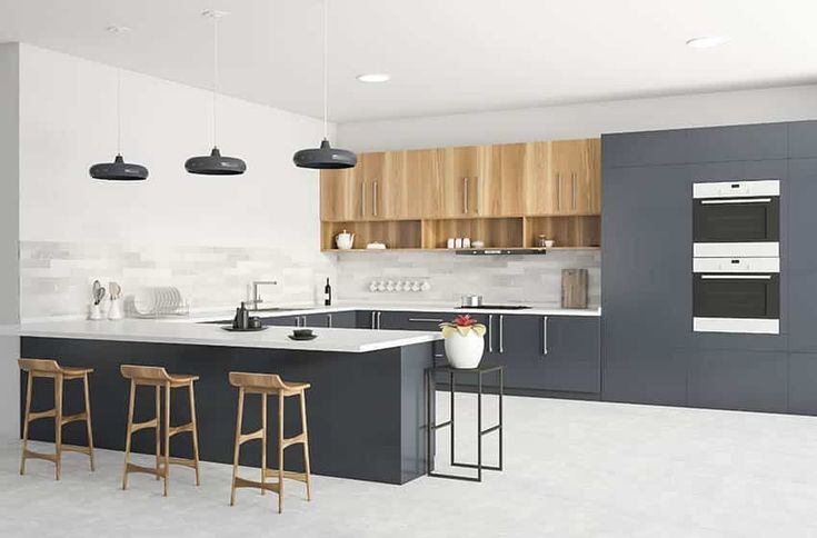 a modern kitchen with an island and bar stools in front of the countertop