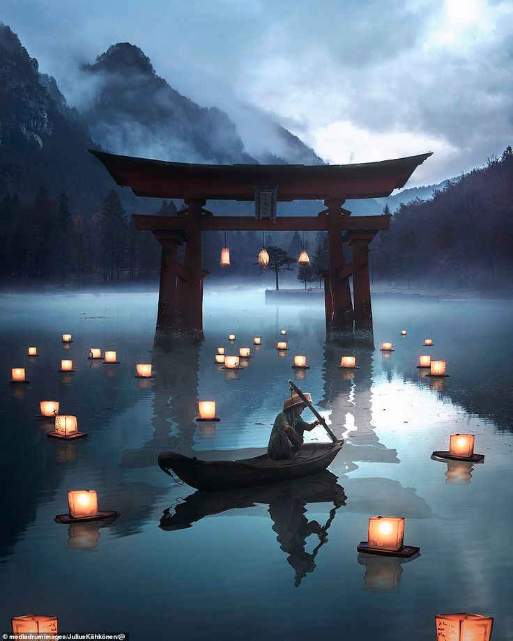 a person in a boat surrounded by lanterns