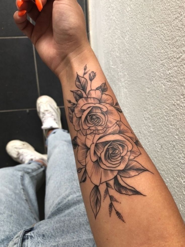 a person with a flower tattoo on their arm