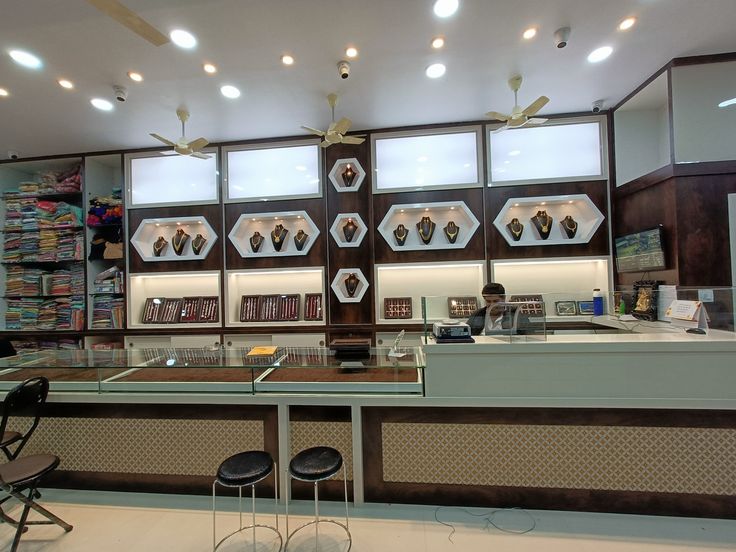 the interior of a book store with several shelves and chairs in front of it,