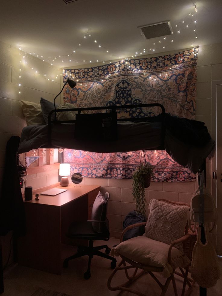 a bunk bed sitting in the middle of a room next to a desk and chair