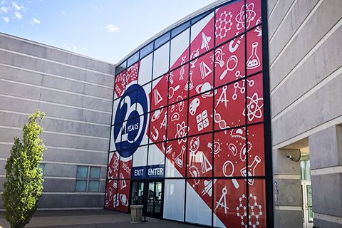 a large building with many windows and symbols on it