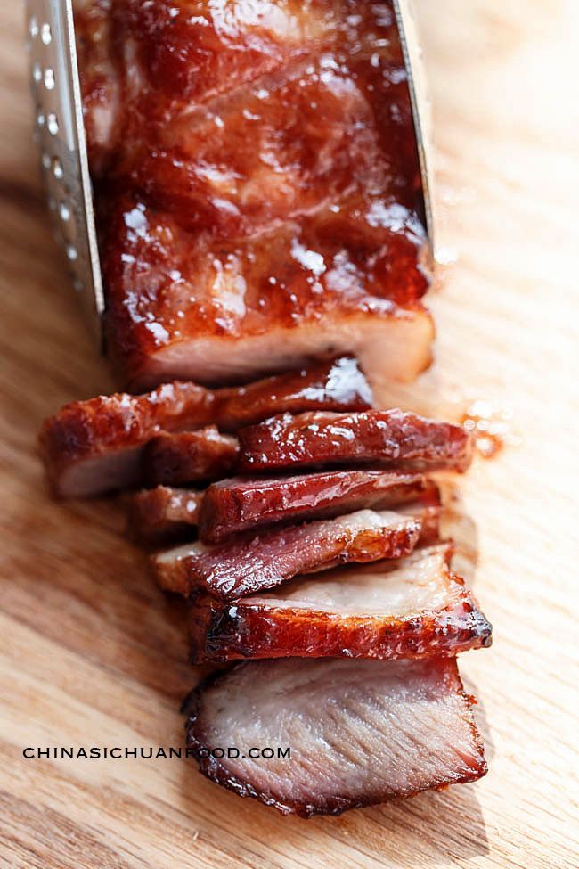 sliced meat sitting on top of a wooden cutting board