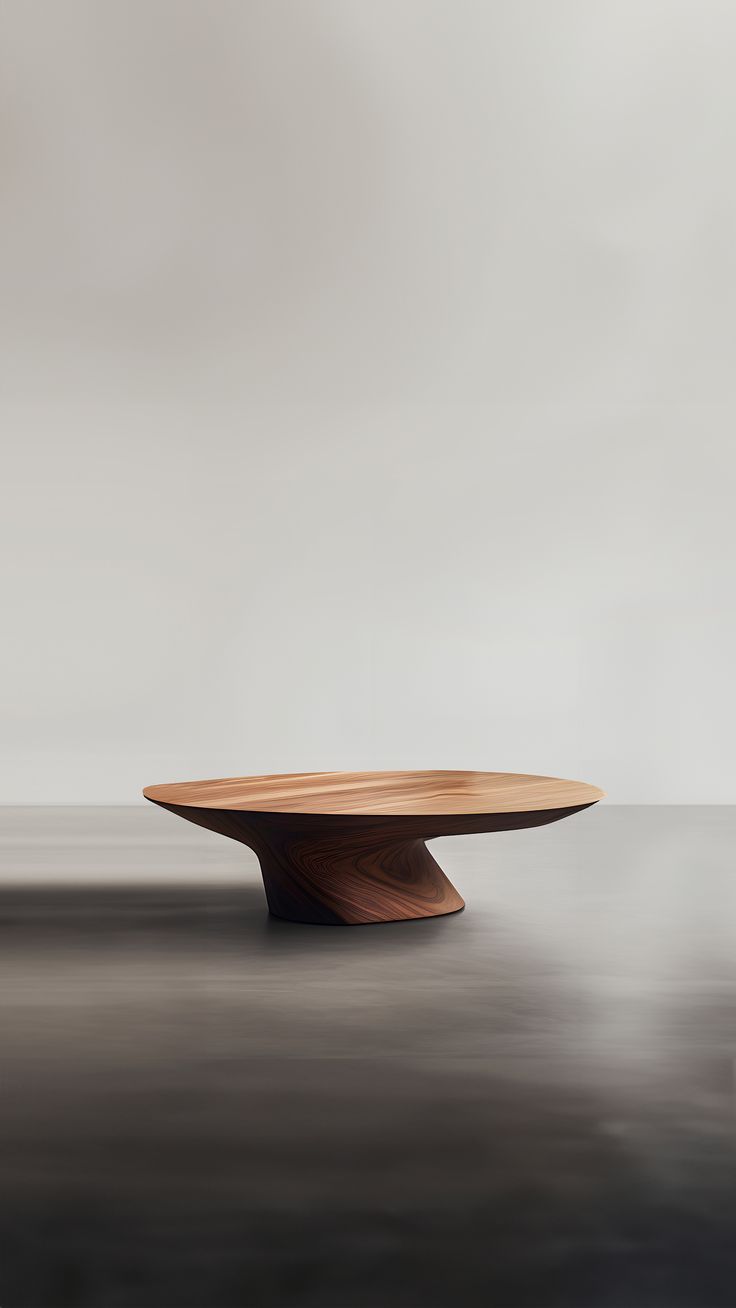 a wooden table sitting on top of a black floor next to a white wall in the background