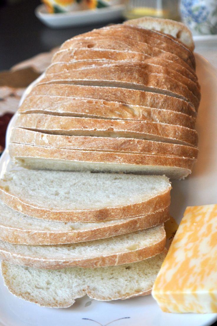 a white plate topped with sliced bread and butter