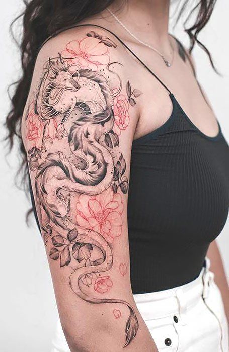 a woman with a dragon tattoo on her arm