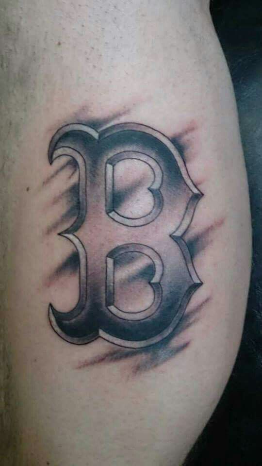 a black and white photo of the letter b on a man's thigh,