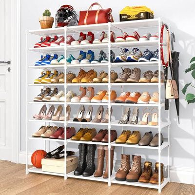 a white shoe rack filled with lots of shoes