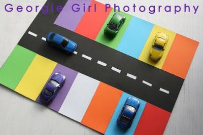 three cars are parked on the road in front of each other, with colorful stripes