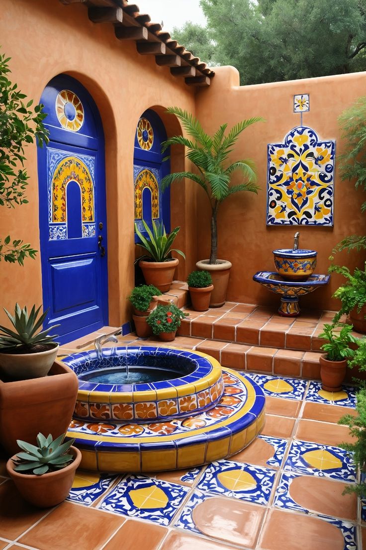 a blue and yellow water fountain surrounded by potted plants