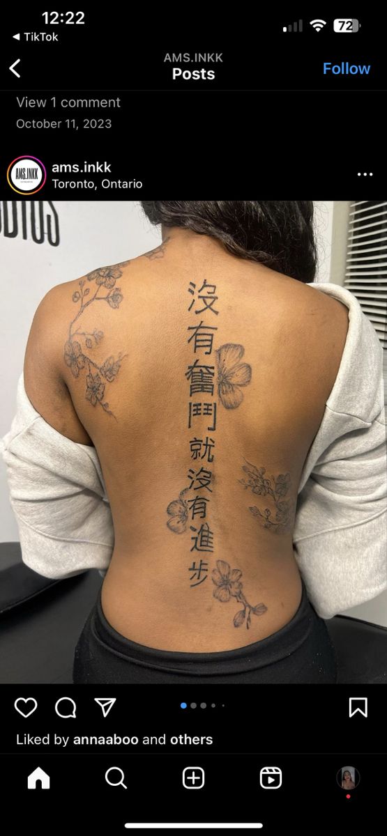 the back of a woman's body with chinese writing on her upper and lower back