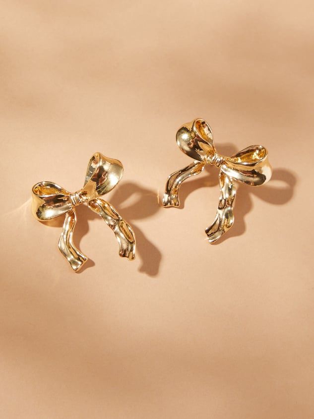 Add a hint of golden glamour to your look with our wavy detail bow earrings, featuring elegant waves for a touch of girly fun. Chic Jewelry With Butterfly Knot For Parties, Chic Party Jewelry With Butterfly Knot, Chic Gold Earrings With Decorative Bow, Chic Gold Earrings With Bow, Gold Earrings With Decorative Bow For Formal Occasions, Elegant Gold Earrings With Bow Tie Detail, Formal Gold Earrings With Decorative Bow, Chic Party Jewelry With Ribbon Detail, Chic Evening Jewelry With Decorative Bow