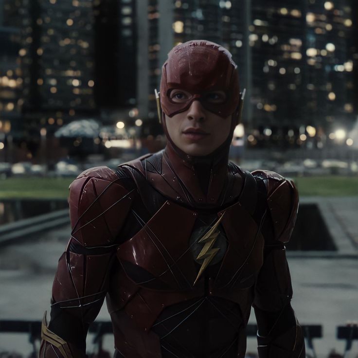 the flash standing in front of a city at night