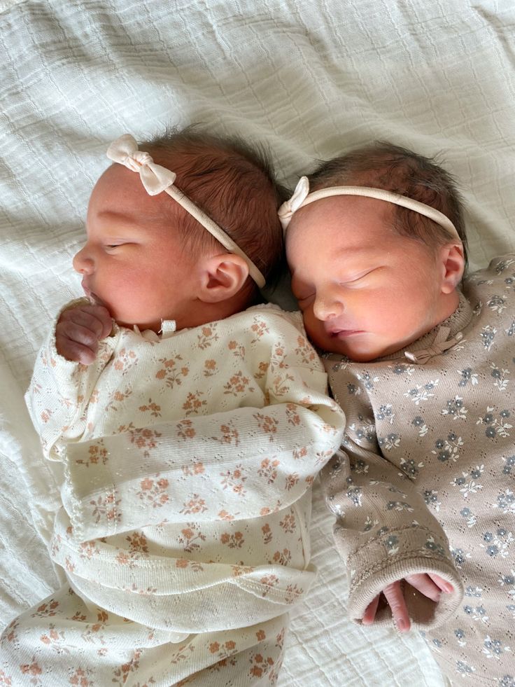 two newborn babies sleeping next to each other