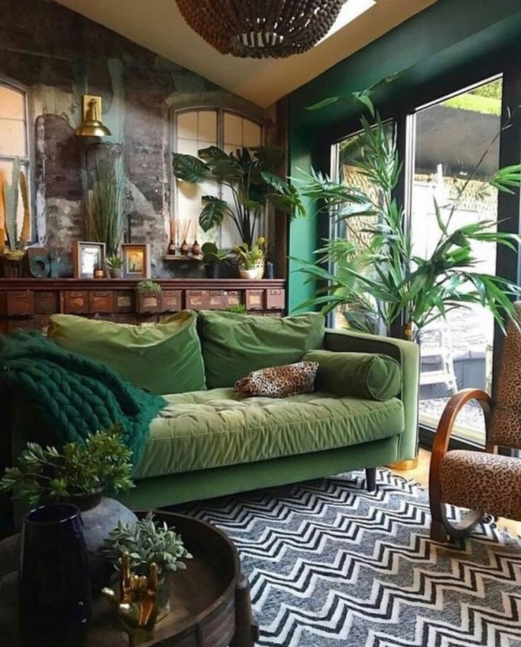 a living room filled with furniture and lots of plants