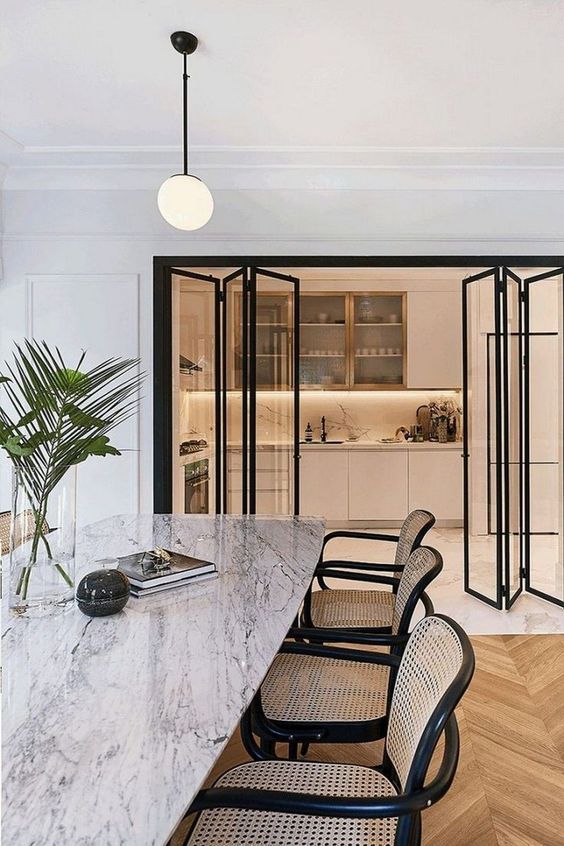 a dining room with marble table and chairs