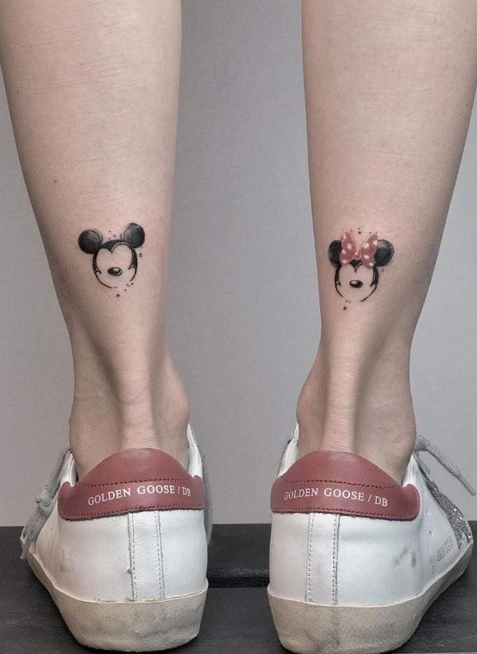 two tattoos on the legs of people with minnie mouse ears and pink flowers in their hair