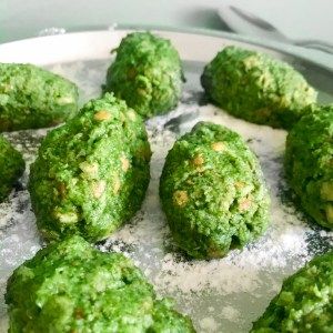 several balls of green food sitting on top of a plate