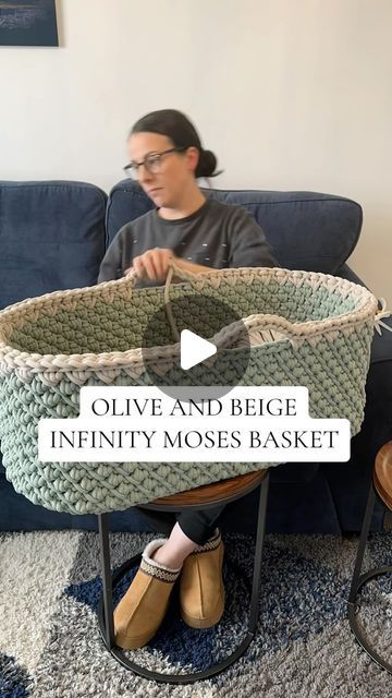 a woman sitting on a couch with a basket in front of her and the words olive and begge infinite mosses basket